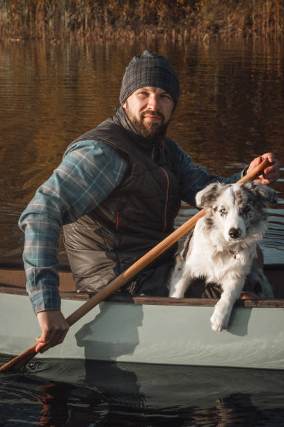 istock Man with a dog in canoe 1199584165