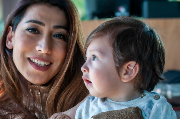 istock Young mother looking her newborn baby boy 1199586209