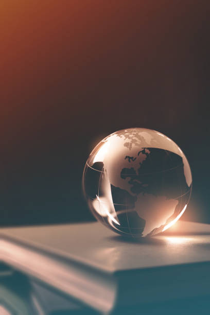 istock Close-up of Glass Globe on a Stack of Books 1199586248