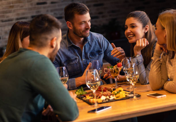 Group of young friends having fun in restaurant.