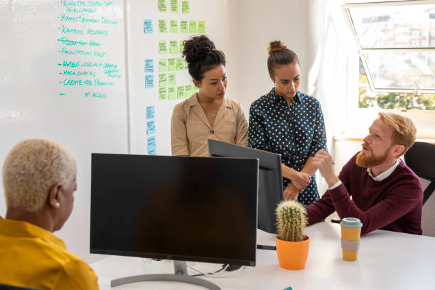 istock Small Business Entrepreneurs Brainstorming in an Open Plan Office 1199587247