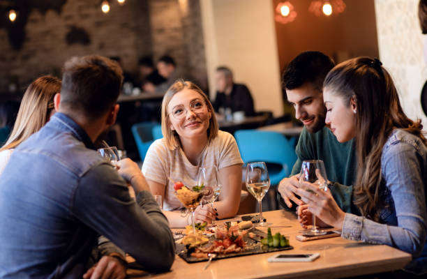 istock Group of young friends having fun in restaurant. 1199587316