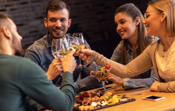 istock Group of young friends having fun in restaurant. 1199587329