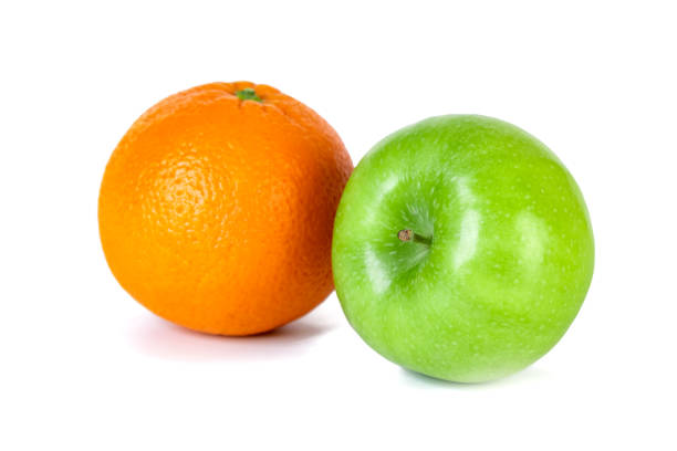 istock Green apple and orange isolated on white background 1199587360