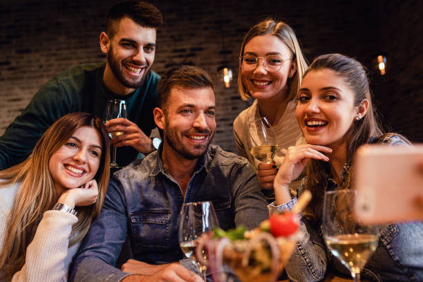 istock Group of young friends having fun in restaurant. 1199587370