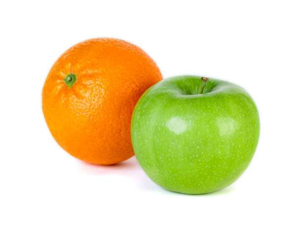 istock Green apple and orange isolated on white background 1199587373