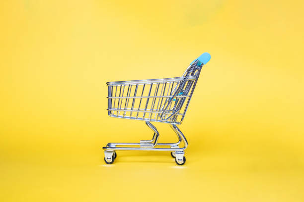 Empty top view mini blue sky shopping cart  or trolley shopping on yellow gold background,theme gold for chinese new year .Concept shopping in supermarket. stock photo
