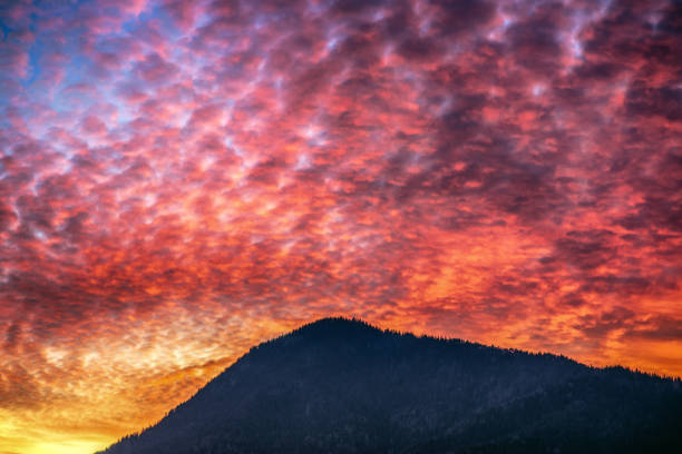 Colorful evening orange clouds on the sky and silhouette of  mountains at background. Hill Sidorovo at Slovakia
