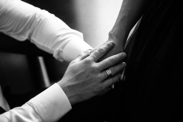 istock Man and woman hold hands close up 1199595879