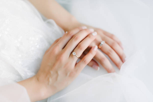 istock Man and woman hold hands close up 1199596878