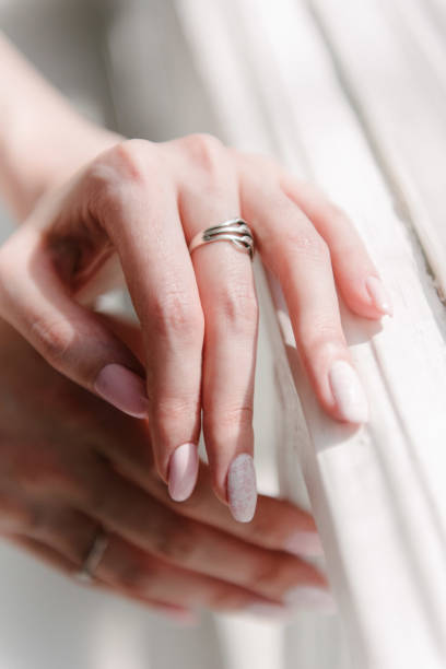 istock Man and woman hold hands close up 1199596890