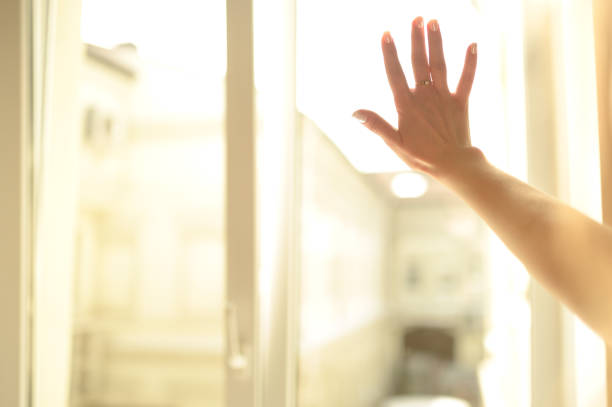 istock Male and female Hands on a misted window close-up. 1199596918
