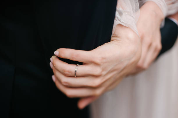 istock Man and woman hold hands close up 1199598482