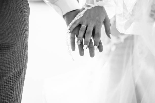 istock Man and woman hold hands close up 1199598641