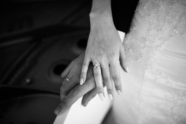 istock Man and woman hold hands close up 1199598664