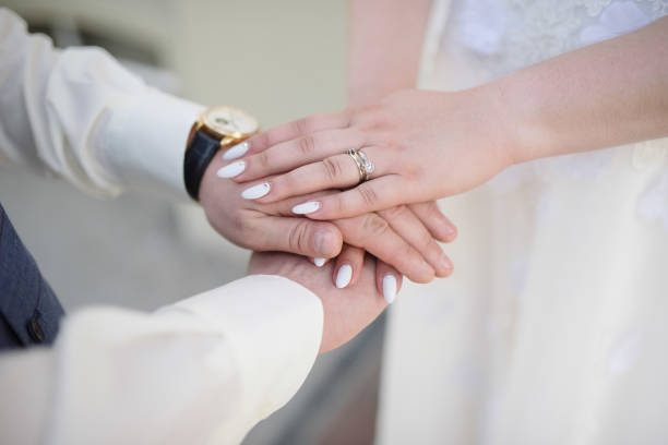 istock Man and woman hold hands close up 1199598665