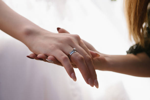 istock Man and woman hold hands close up 1199598762