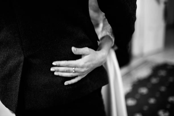 istock Man and woman hold hands close up 1199599105