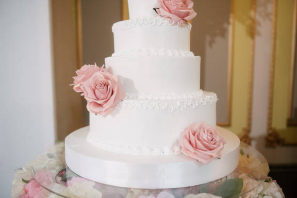 istock Big white wedding cake with fruit is on the table 1199601529
