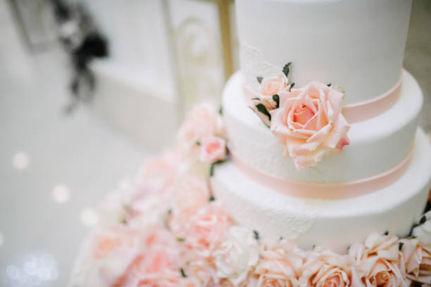 istock Big white wedding cake with fruit is on the table 1199601584