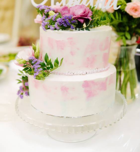 istock Big white wedding cake with fruit is on the table 1199601616