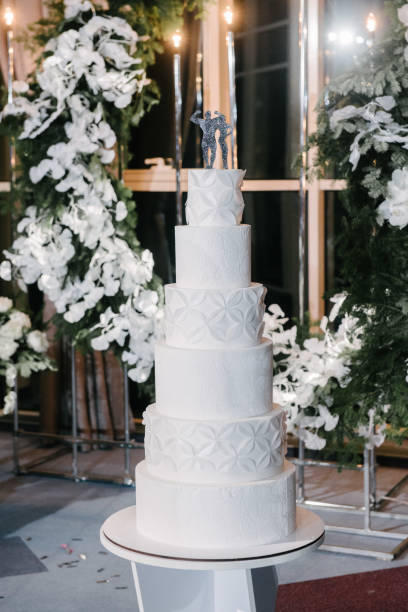 istock Large white wedding cake with castle shaped towers 1199601654