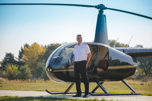 istock Helicopter pilot standing by grounded helicopter 1199602982