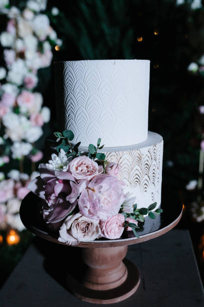 istock Big white wedding cake with fruit is on the table 1199604241