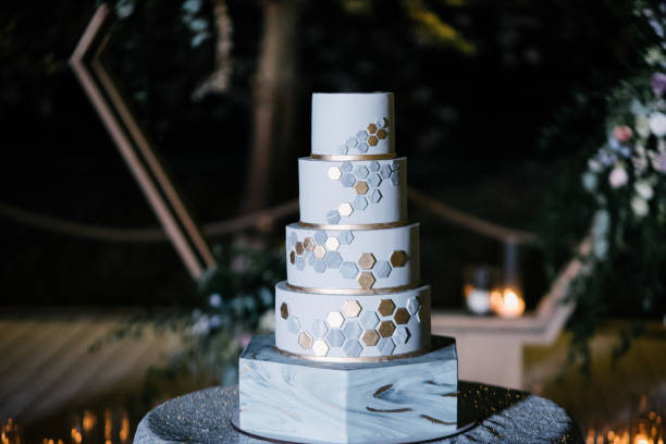 istock Large white wedding cake with castle shaped towers 1199604304