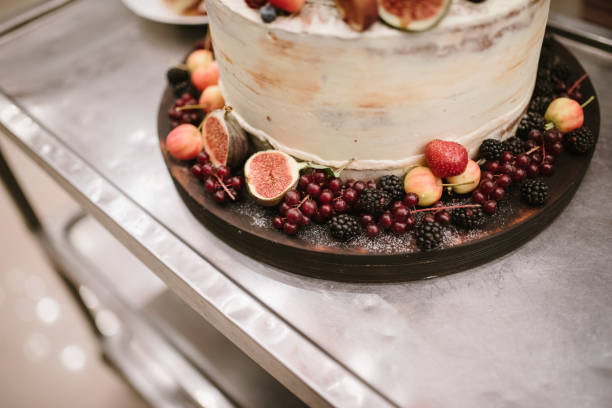 istock Big white wedding cake with fruit is on the table 1199604425