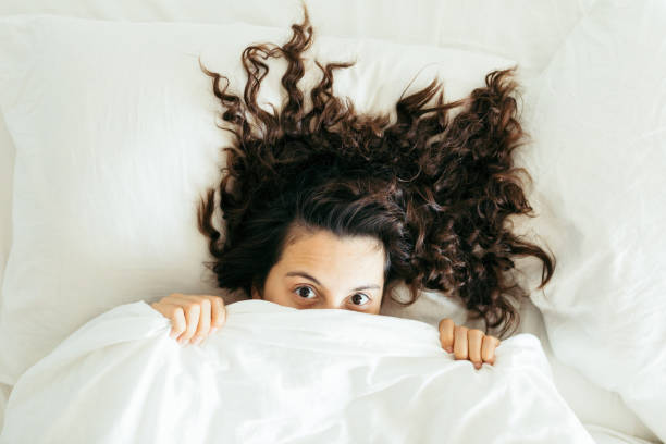 istock woman having fun in bed 1199604713