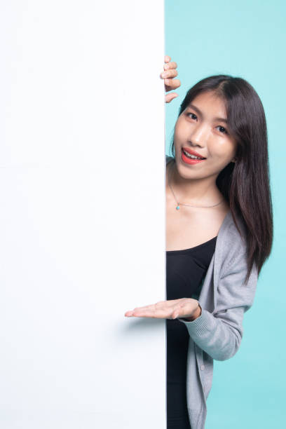 istock Young Asian woman present blank sign with palm hand. 1199604904