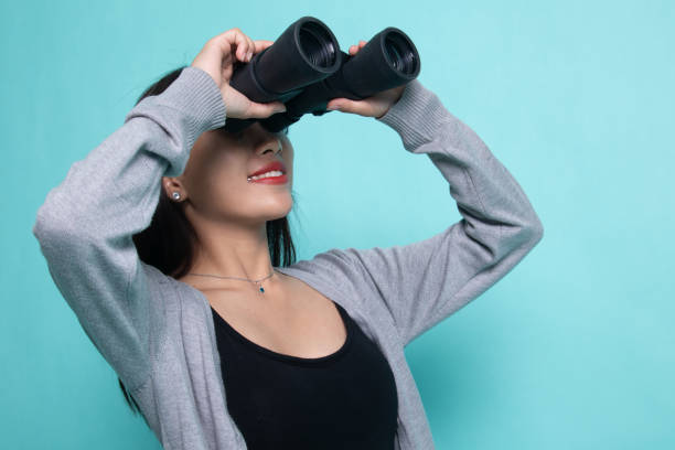 istock Young Asian woman with binoculars. 1199605290