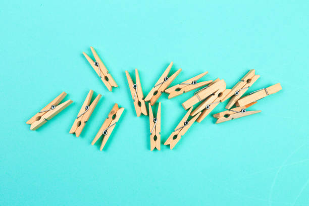 istock wooden cloth pegs on blue  background - Image 1199606143