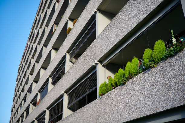 Indiviuality concept, green balcony among gray balconies.