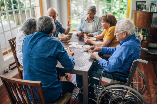 istock Senior friends having fun playing cards 1199607671
