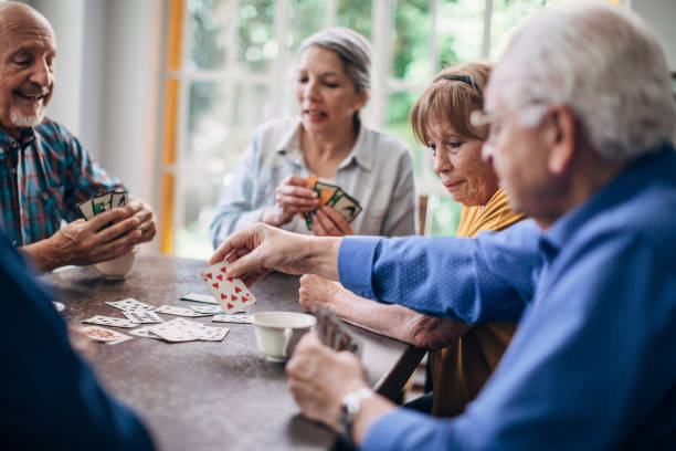 istock Senior friends having fun playing cards 1199607751