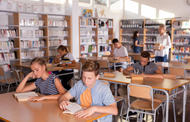 istock Teenagers  in school library 1199608757