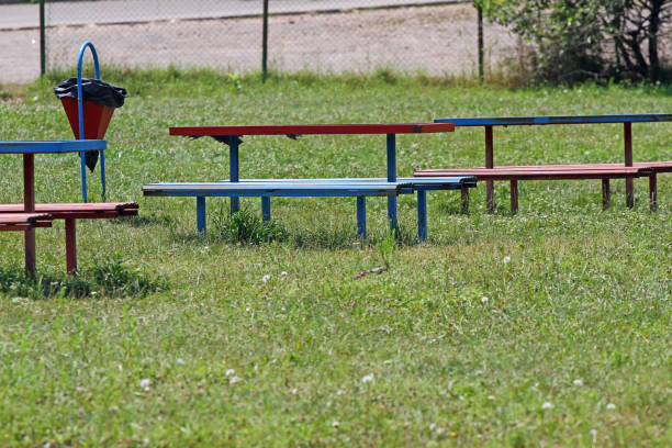 istock Benches and a trash bin in the grass outside in nature 1199611457