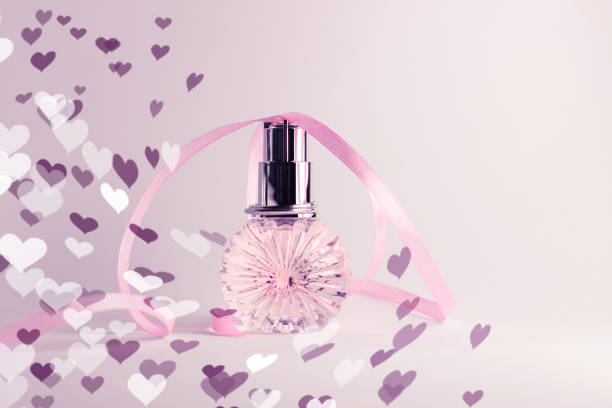 Close-up photo of pink perfumes on white background.