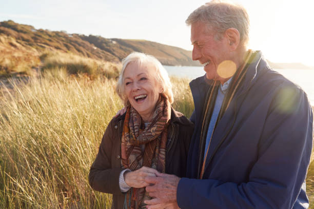 istock Loving Active Senior Couple Arm In Arm Walking Through Sand Dunes 1199612043