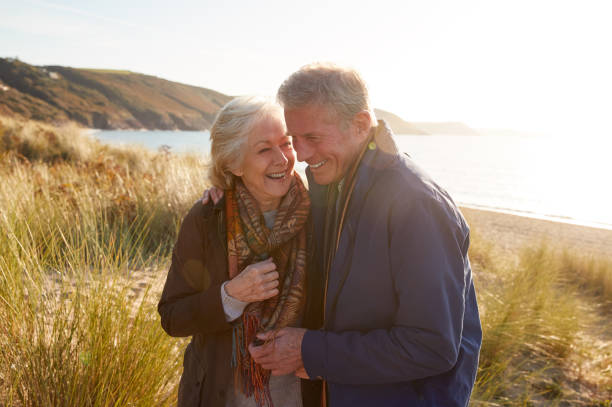 istock Loving Active Senior Couple Arm In Arm Walking Through Sand Dunes 1199612116