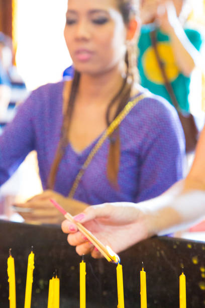 istock Woman praying in Thai temple 1199612897