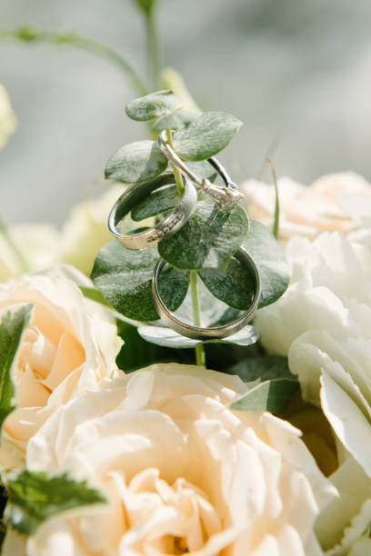 istock Wedding rings lie on a flower close up 1199613597