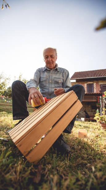 istock Senior man repairs wooden drawer 1199616440