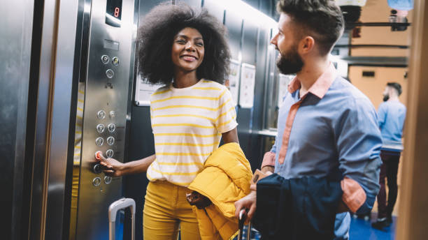 istock Young couple arriving at the hotel and using elevator 1199617166