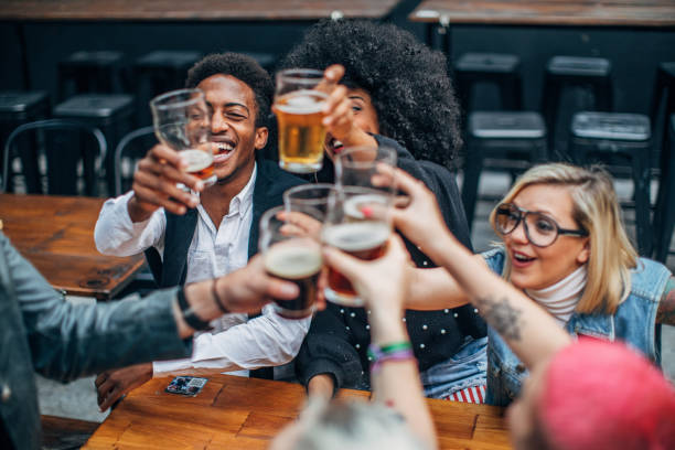 istock Friends drinking beer outdoors in pub 1199617171