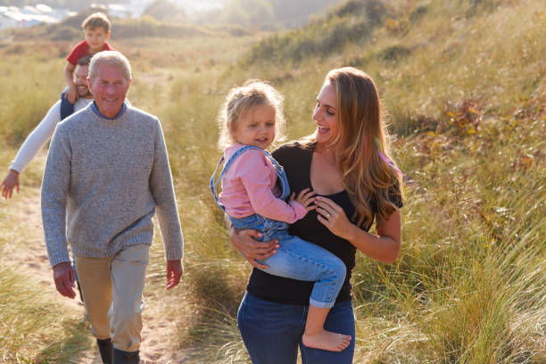 istock Multi-Generation Family Walking Along Path Through Sand Dunes Together 1199617298