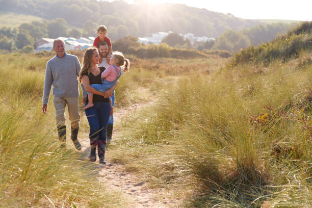 istock Multi-Generation Family Walking Along Path Through Sand Dunes Together 1199617312