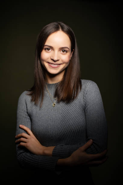 istock Confident young woman on dark background 1199617856